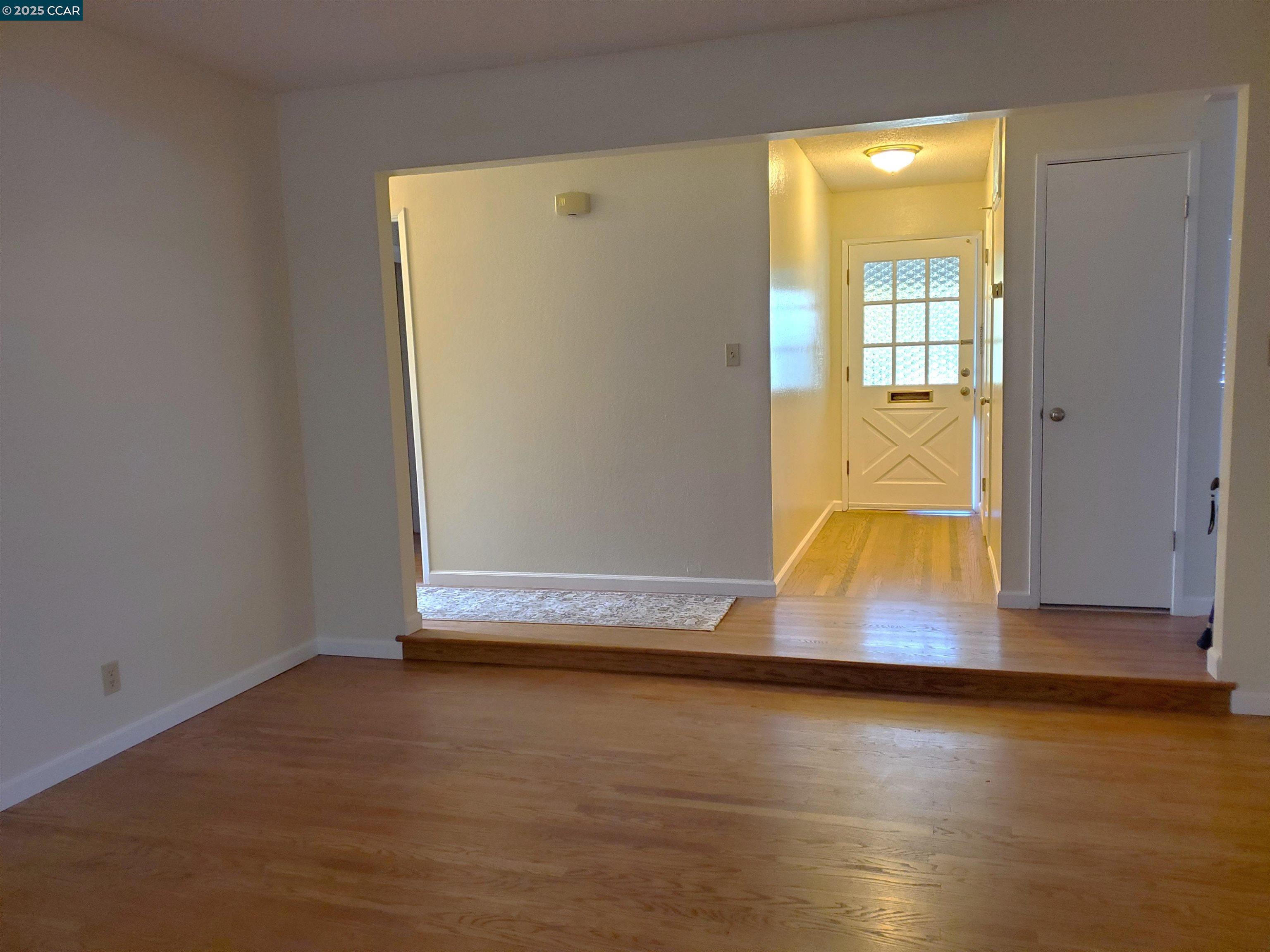 1616 Eve Drive Concord, CA 94521 - Photo 20 of 28 an empty room with wooden floor and windows