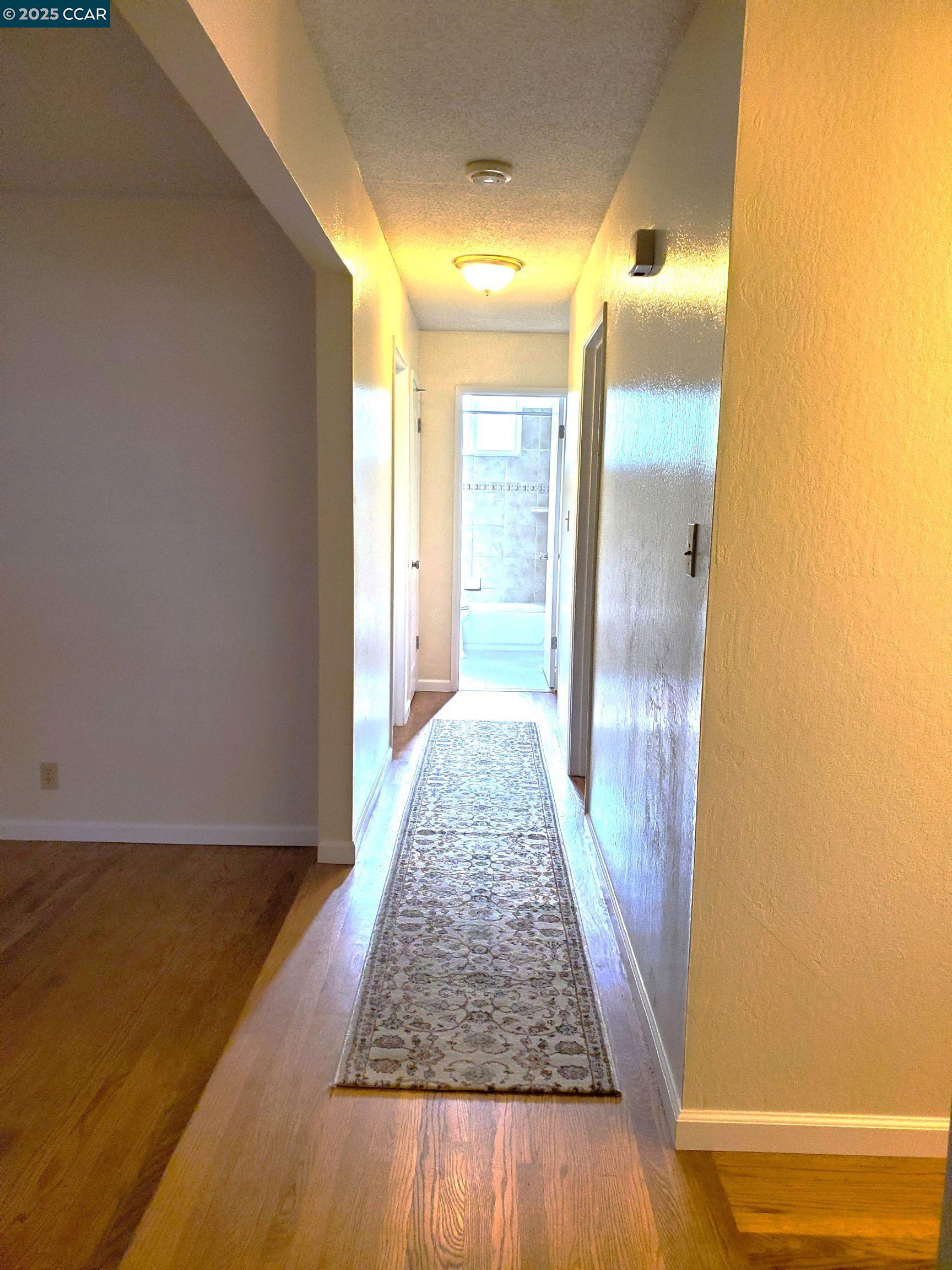 1616 Eve Drive Concord, CA 94521 - Photo 21 of 28 a view of a hallway with wooden floor