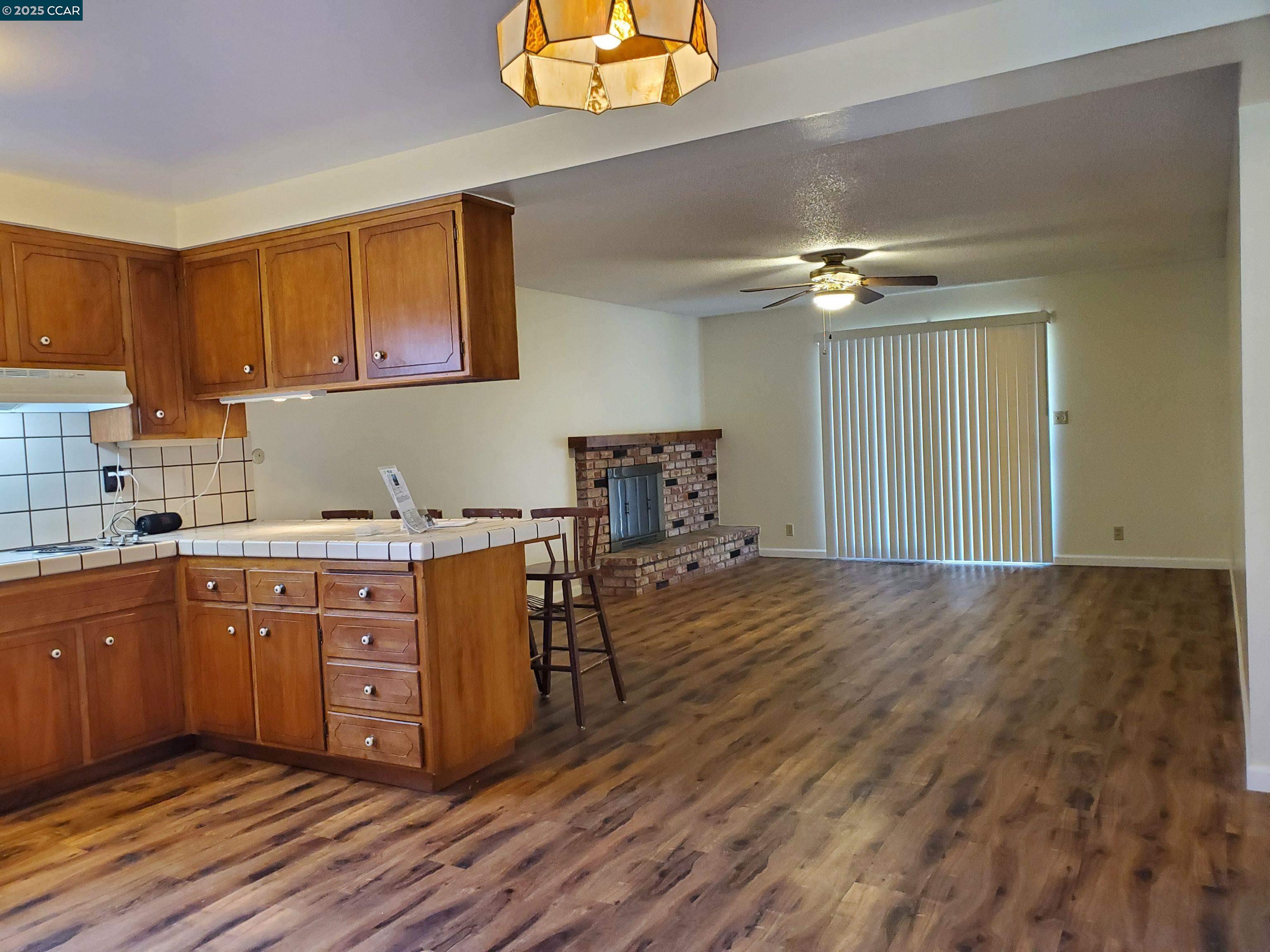 1616 Eve Drive Concord, CA 94521 - Photo 23 of 28 a kitchen with sink cabinets and wooden floor