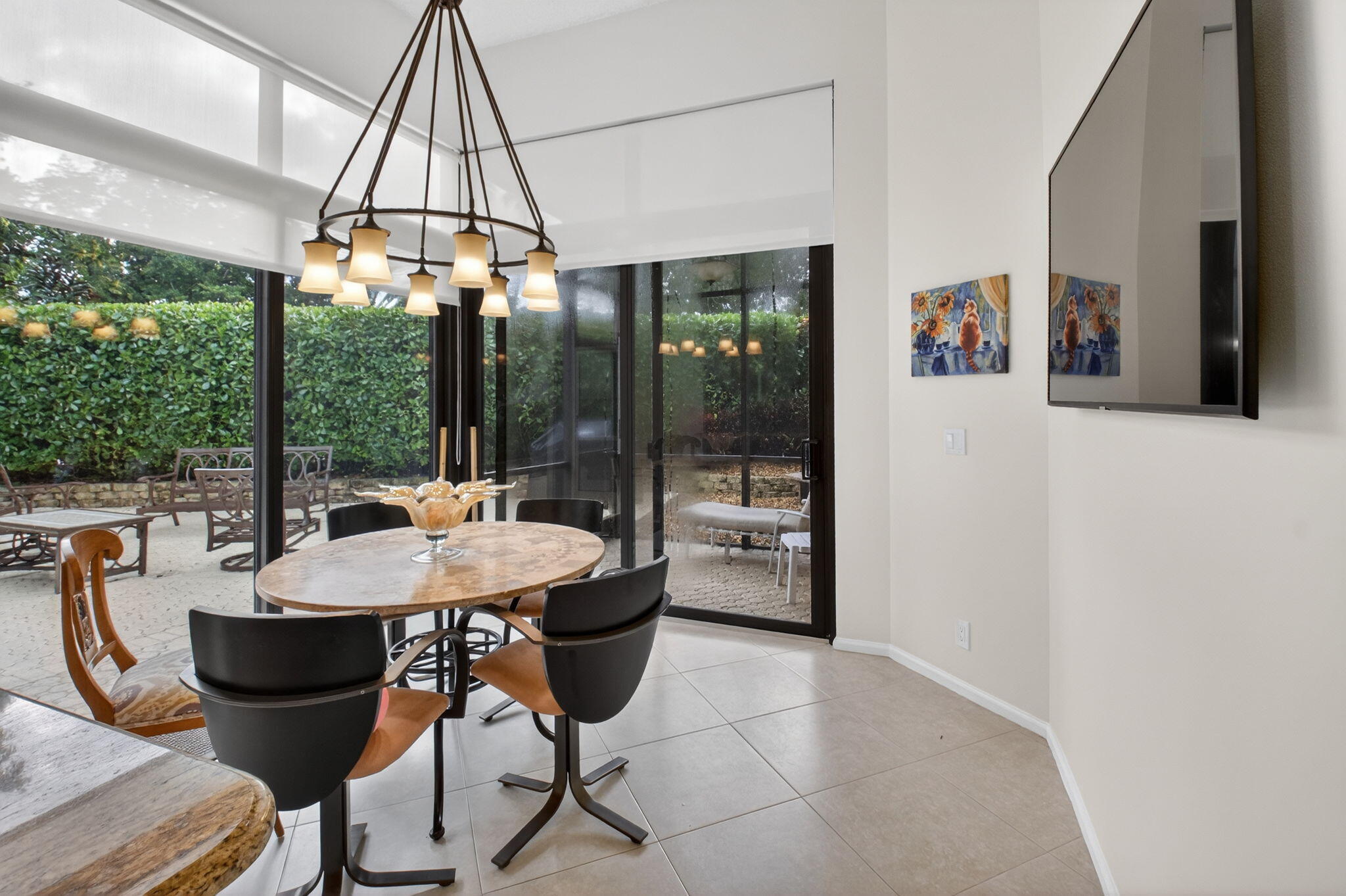 2462 Northwest 63rd Street Boca Raton, FL 33496 - Photo 12 of 41 a view of a dining room with furniture wooden floor and chandelier
