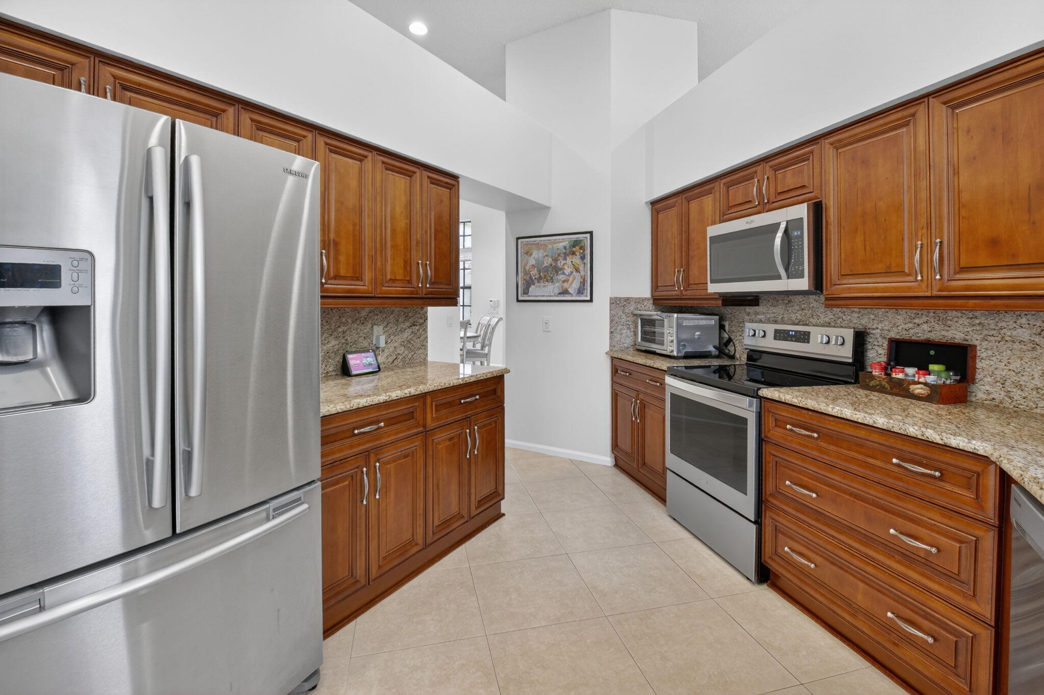 2462 Northwest 63rd Street Boca Raton, FL 33496 - Photo 14 of 41 a kitchen with stainless steel appliances granite countertop a refrigerator stove top oven and sink