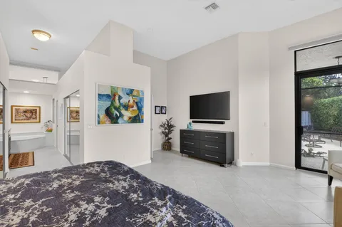 a bedroom with furniture and flat screen tv