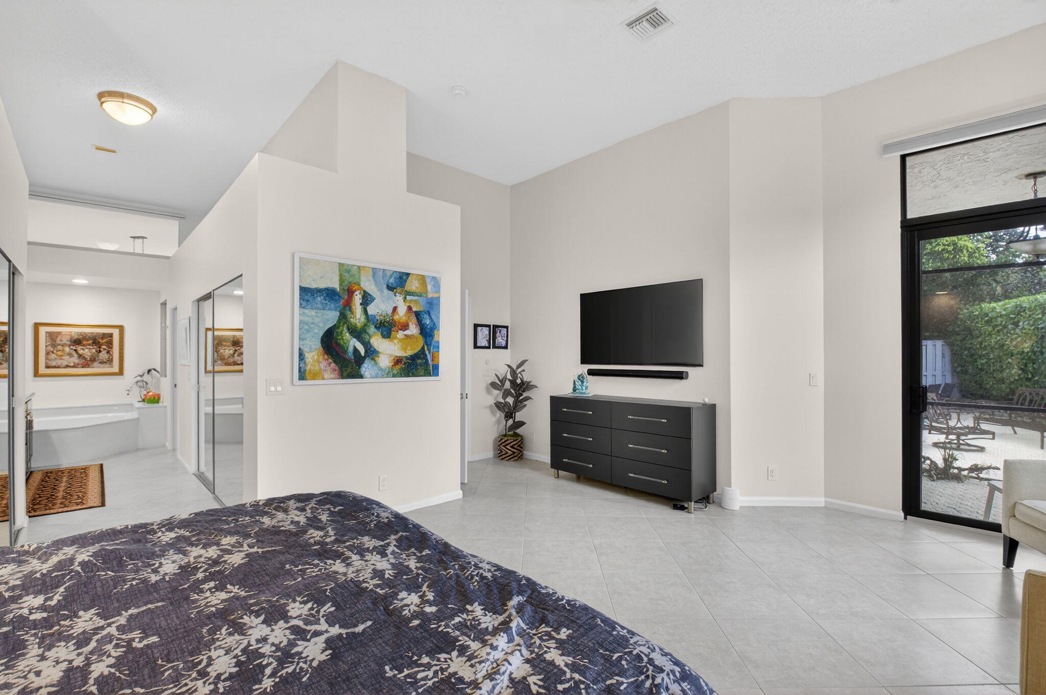 2462 Northwest 63rd Street Boca Raton, FL 33496 - Photo 17 of 41 a bedroom with furniture and flat screen tv