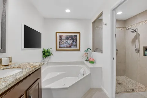 a bath tub sitting next to a bathroom sink