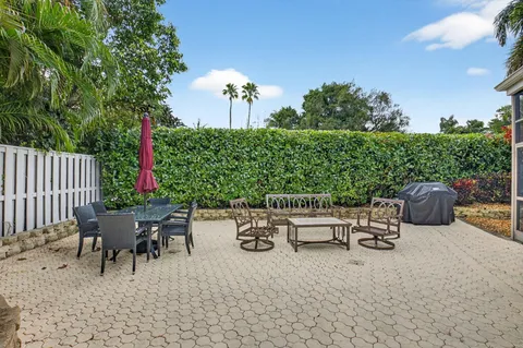 a view of a backyard with furniture and a garden