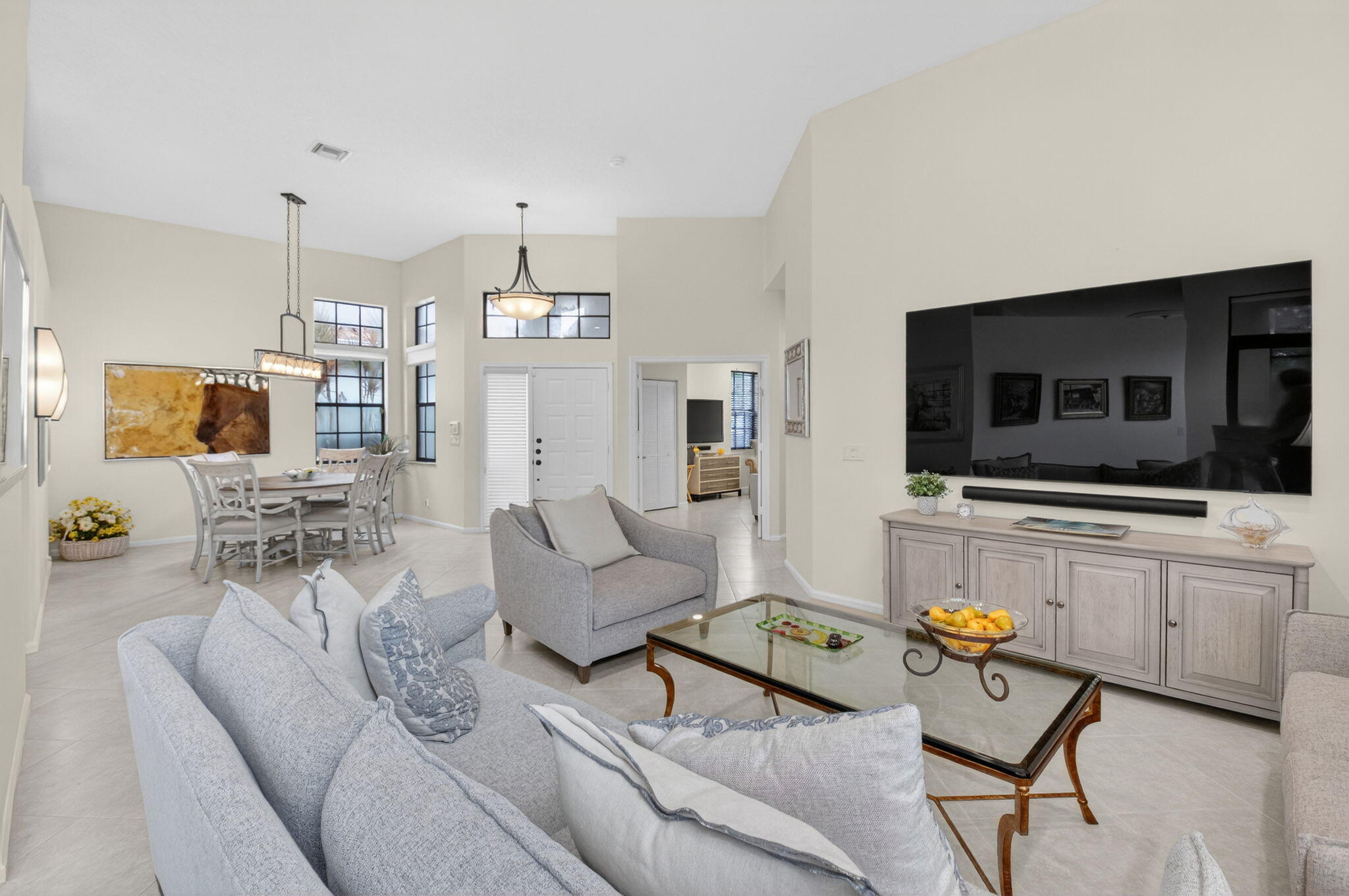 2462 Northwest 63rd Street Boca Raton, FL 33496 - Photo 6 of 41 a living room with furniture and a flat screen tv