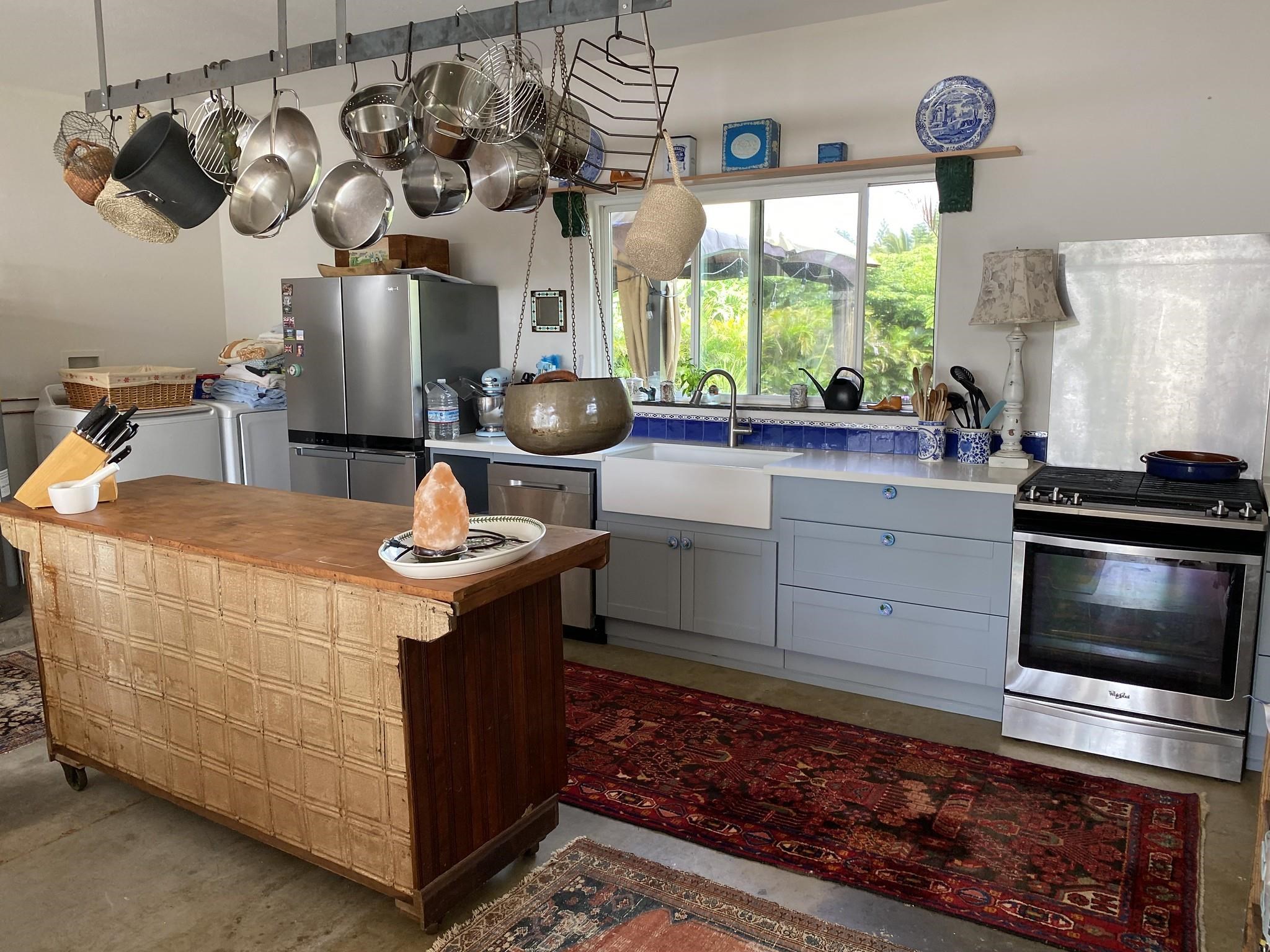 230 North Holokai Road, Unit B Haiku, HI 96708 - Photo 13 of 36 a kitchen with stainless steel appliances granite countertop a sink stove and window