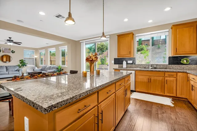 a kitchen with stainless steel appliances granite countertop a refrigerator stove and microwave