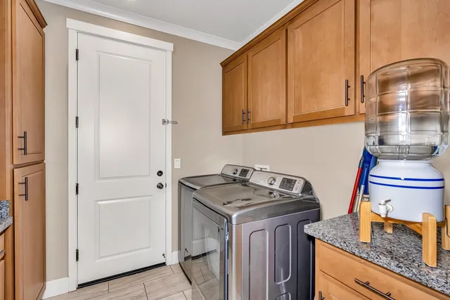 a bathroom with a granite countertop sink a toilet and a large mirror