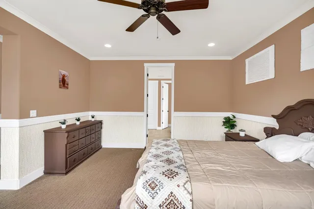 a spacious bedroom with a large bed and a large window