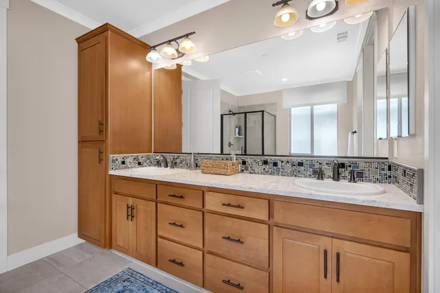 an aerial view of ocean and residential houses with outdoor space