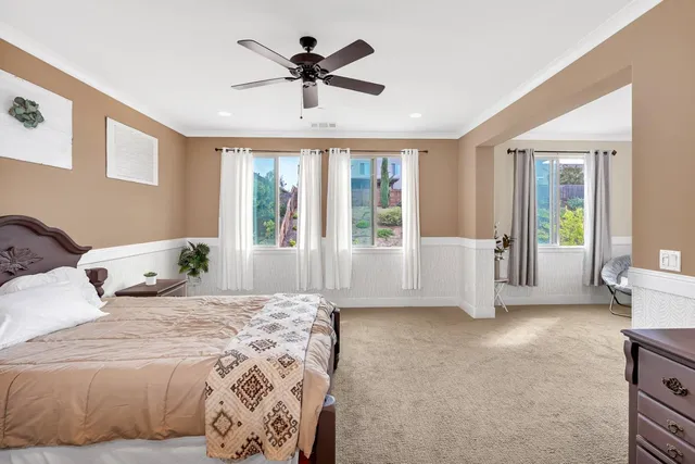 an aerial view of residential houses with outdoor space and parking