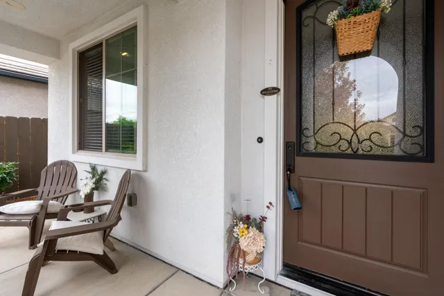 a view of backyard with outdoor seating and plants