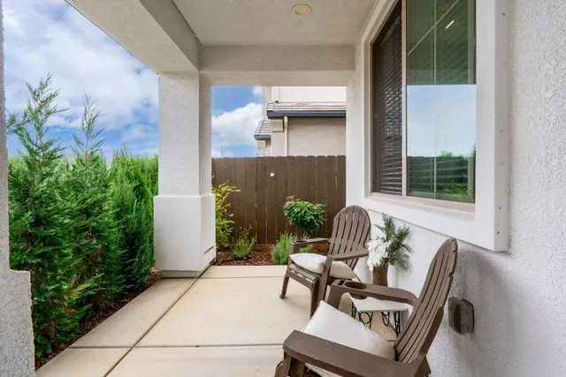 a view of a hallway with wooden floor and a bathroom