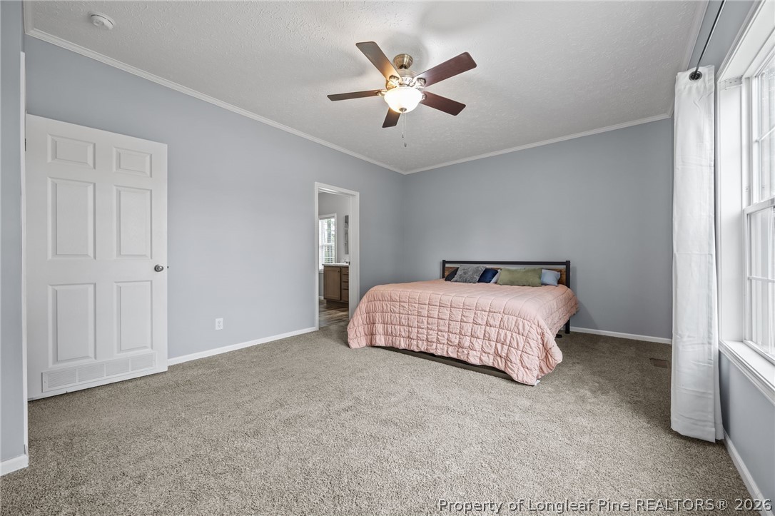 2252 Old Stage Road South Erwin, NC 28339 - Photo 26 of 47 a bedroom with a bed and a ceiling fan