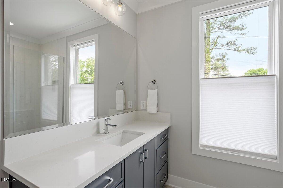 811 Maple Berry Lane, Unit 101 Raleigh, NC 27607 - Photo 32 of 45 a bathroom with a sink and a window