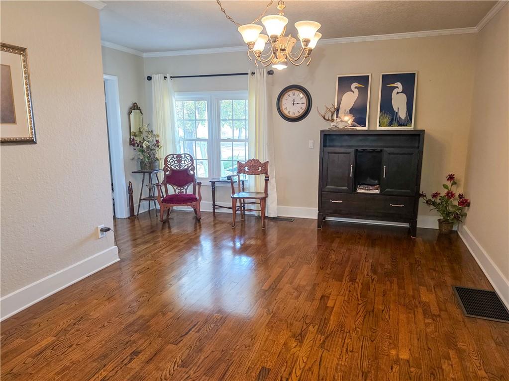 589 Jacksonville Scotland Road Jacksonville, GA 31544 - Photo 12 of 87 an empty room with wooden floor and large window