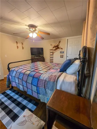a bedroom with a bed and a chandelier