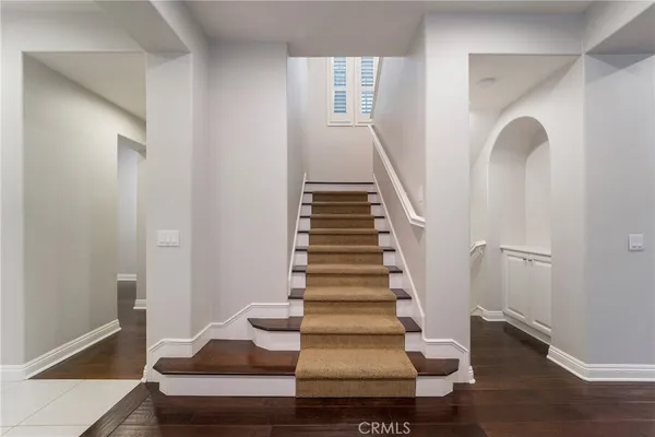 a view of entryway and hall with wooden floor