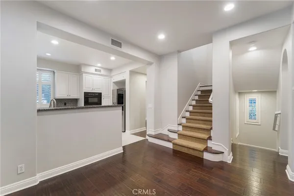 a view of a room with wooden floors and stairs