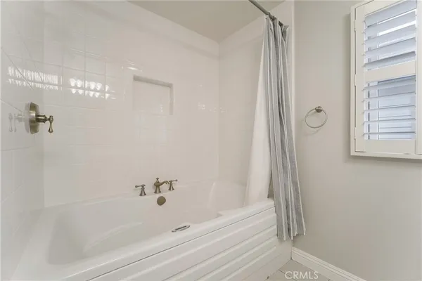 a bathroom with bathtub and shower