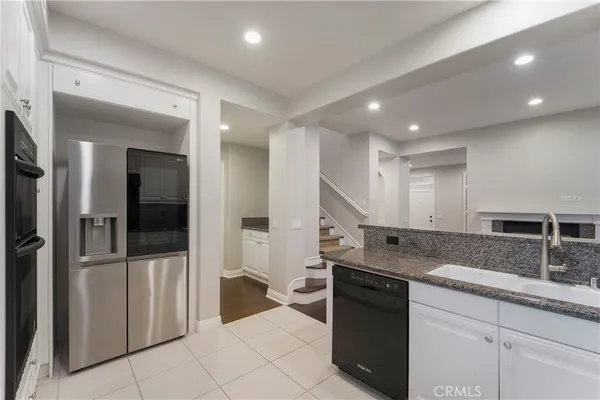 a kitchen with a sink and refrigerator