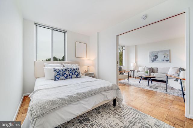 a bedroom with a bed a couch and a window