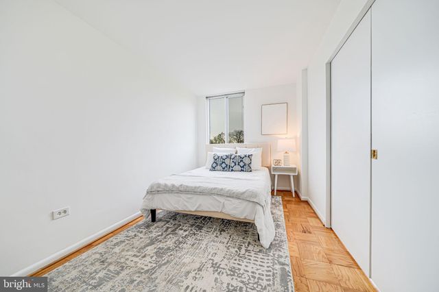 a bedroom with a bed and a mirror