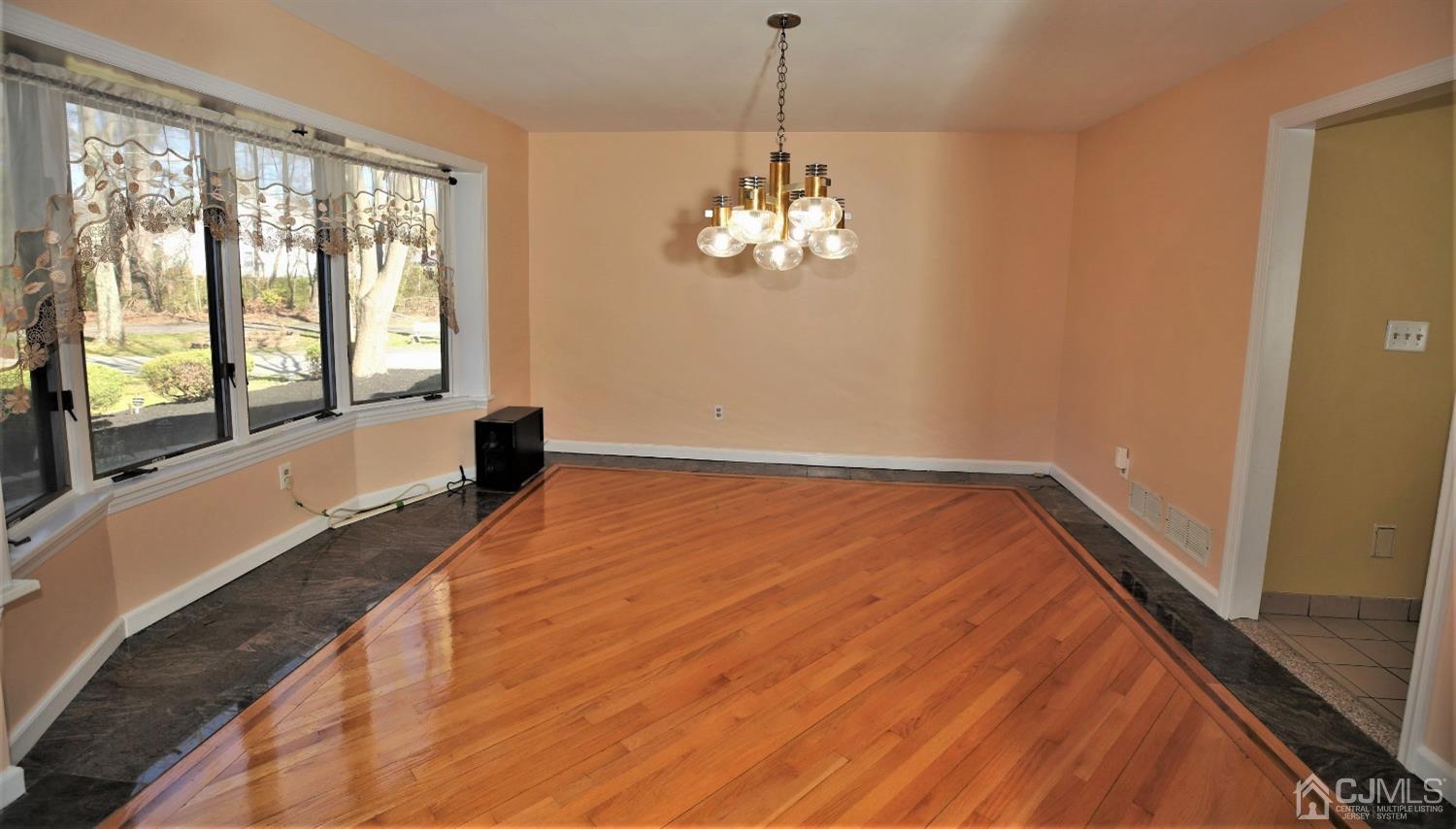 55 Friendship Road Cranbury, NJ 08512 - Photo 13 of 71 a view of a room with wooden floor and chandelier