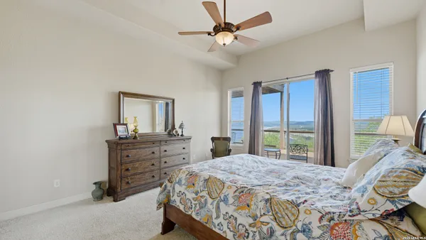a bedroom with a bed dresser and a window