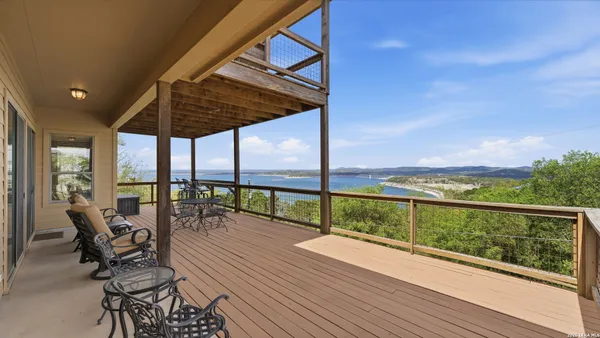 a view of balcony with chairs and wooden floor
