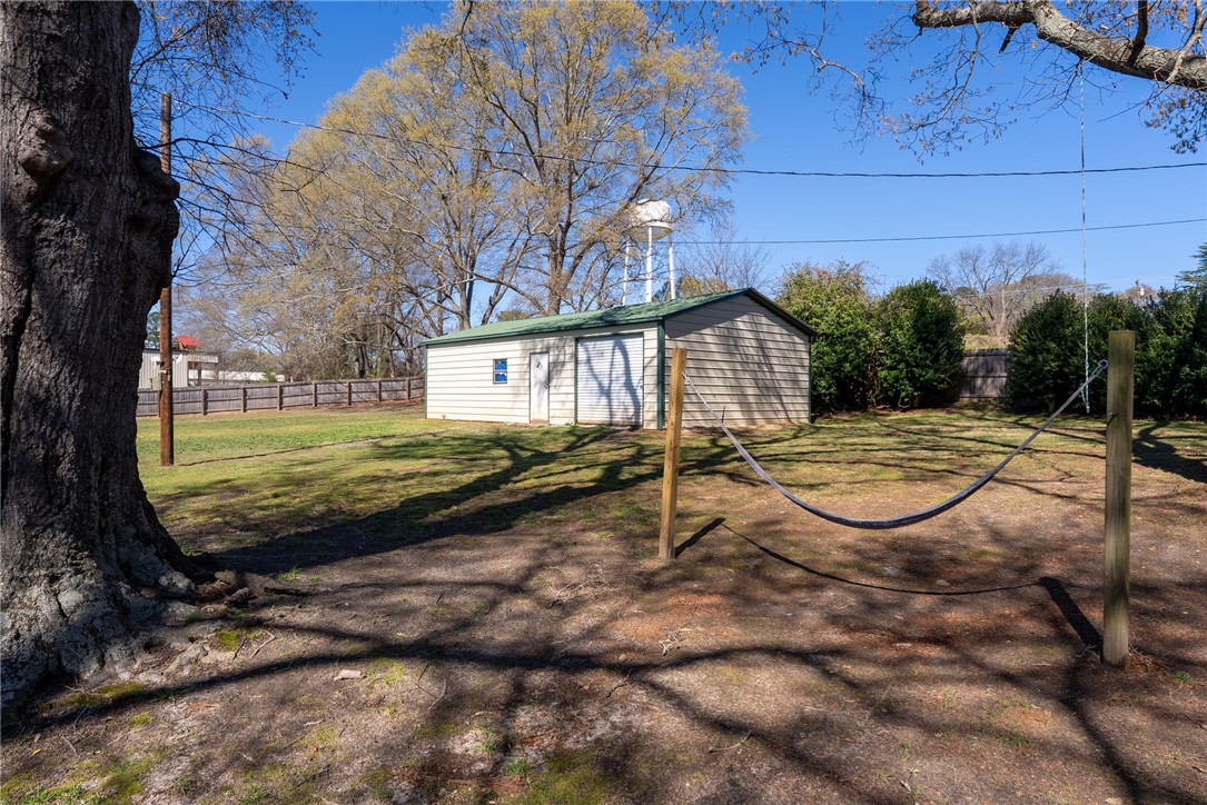 300 Green Street Williamston, SC 29697 - Photo 30 of 47 This spacious yard features a versatile outbuilding, offering ample space for storage or creative pursuits.