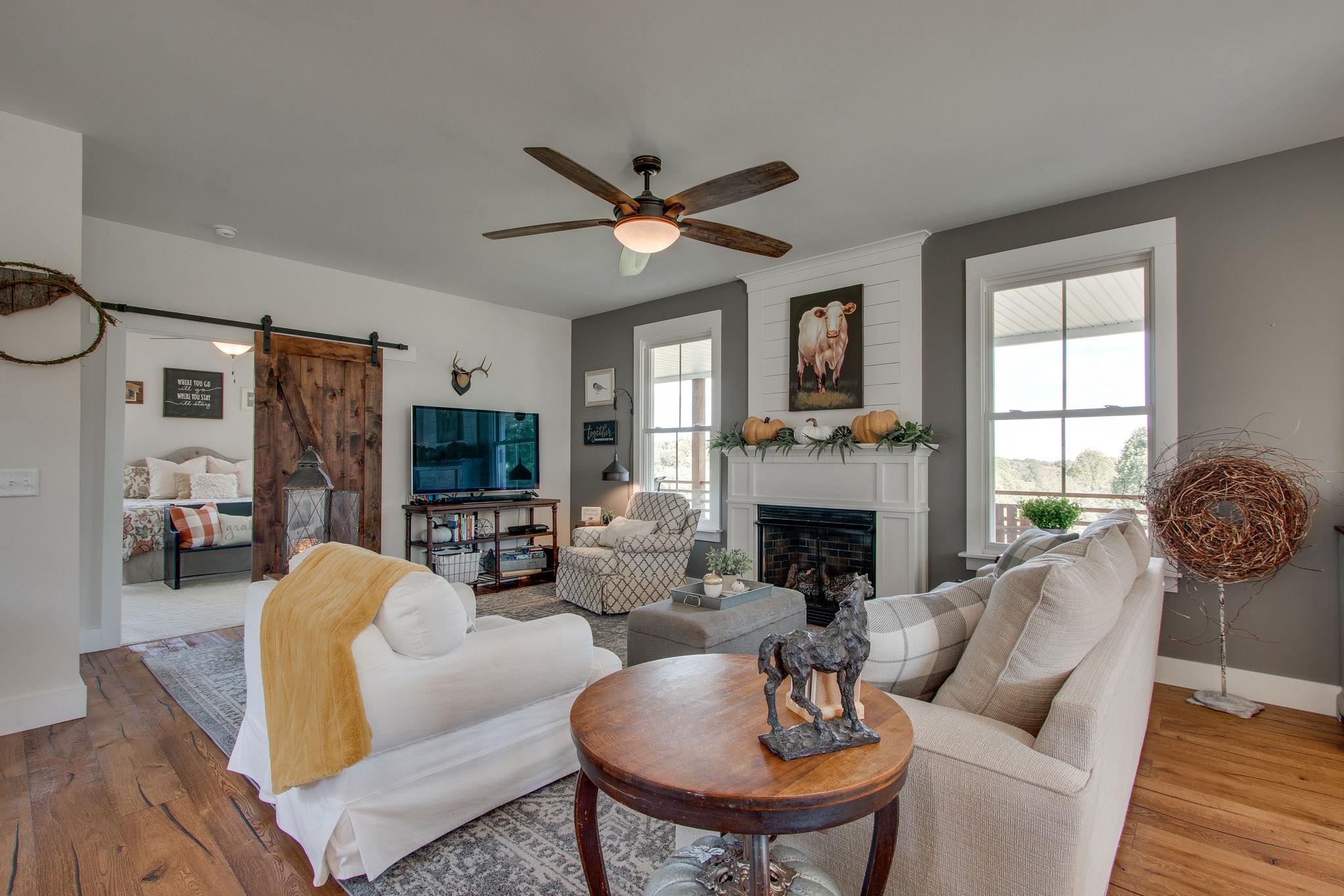 548 Hillview Road North Dickson, TN 37055 - Photo 3 of 30 Enjoy a relaxing conversation with friends as you set around the fireplace and enjoy the natural light streaming in.