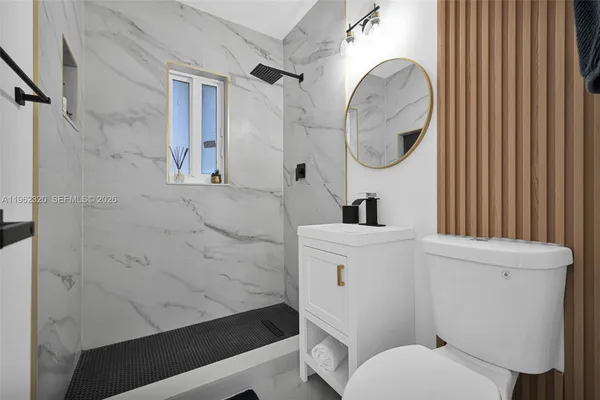 a bathroom with a sink a toilet and a mirror