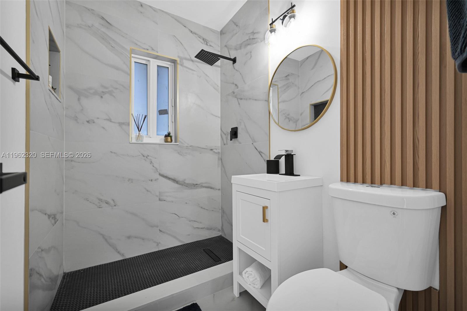 6540 Southwest 4th Street, Unit 6540 Miami, FL 33144 - Photo 11 of 42 a bathroom with a sink a toilet and a mirror