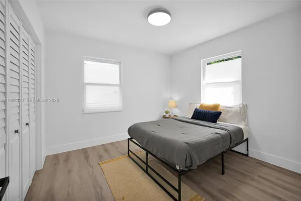 a bedroom with a bed and window