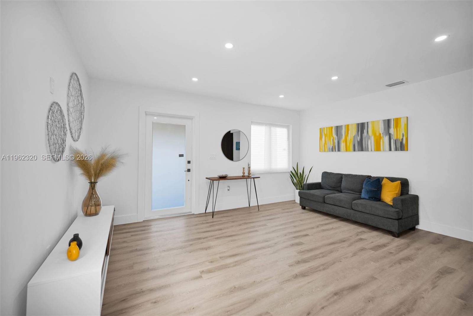 6540 Southwest 4th Street, Unit 6540 Miami, FL 33144 - Photo 16 of 42 a living room with furniture and a wooden floor