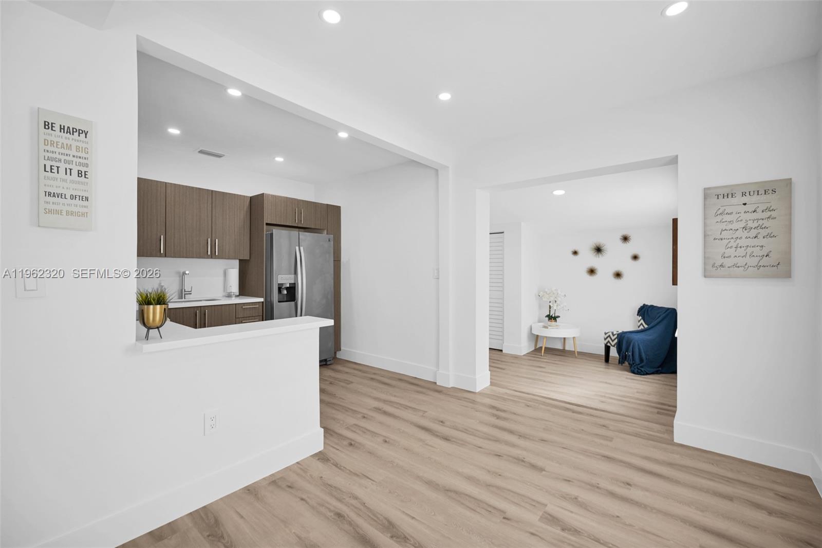 6540 Southwest 4th Street, Unit 6540 Miami, FL 33144 - Photo 18 of 42 a living room with stainless steel appliances furniture a refrigerator and a view of kitchen