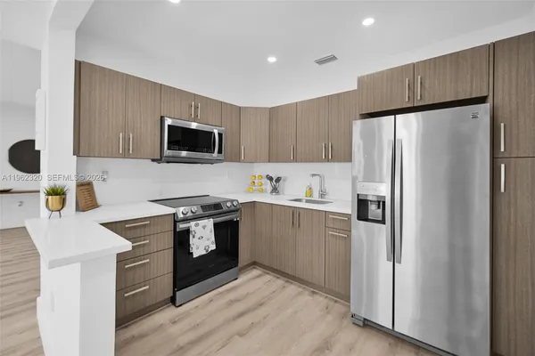 a kitchen with a sink a stove and refrigerator