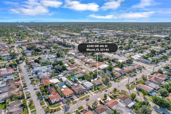 an aerial view of residential building with green space