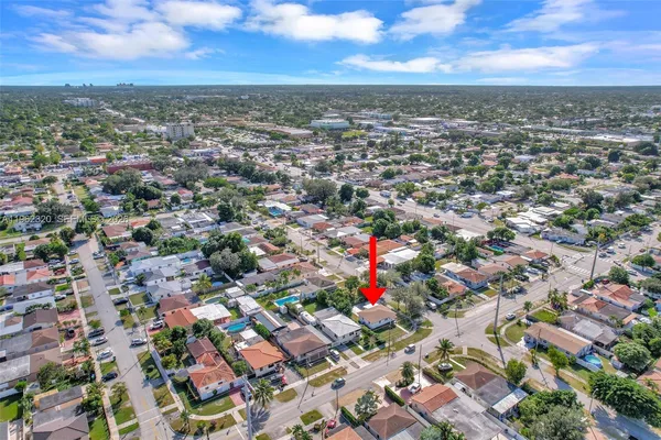an aerial view of residential houses with city and outdoor space