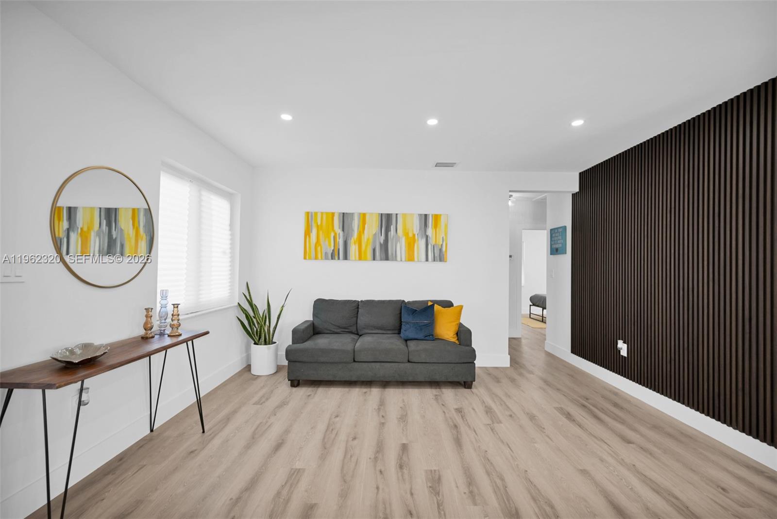 6540 Southwest 4th Street, Unit 6540 Miami, FL 33144 - Photo 7 of 42 a living room with a couch and a wooden floor