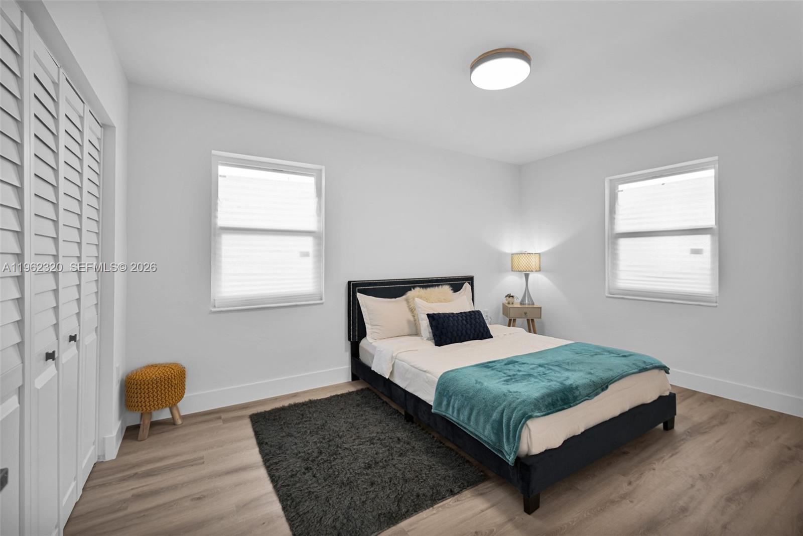 6540 Southwest 4th Street, Unit 6540 Miami, FL 33144 - Photo 8 of 42 a bedroom with a bed lamp and a window