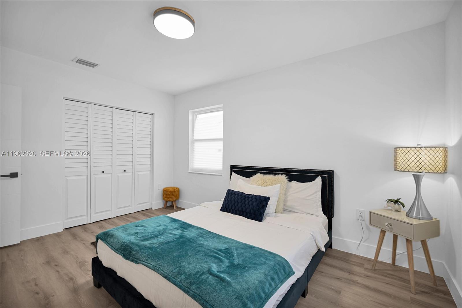 6540 Southwest 4th Street, Unit 6540 Miami, FL 33144 - Photo 9 of 42 a bedroom with a bed and wooden floor