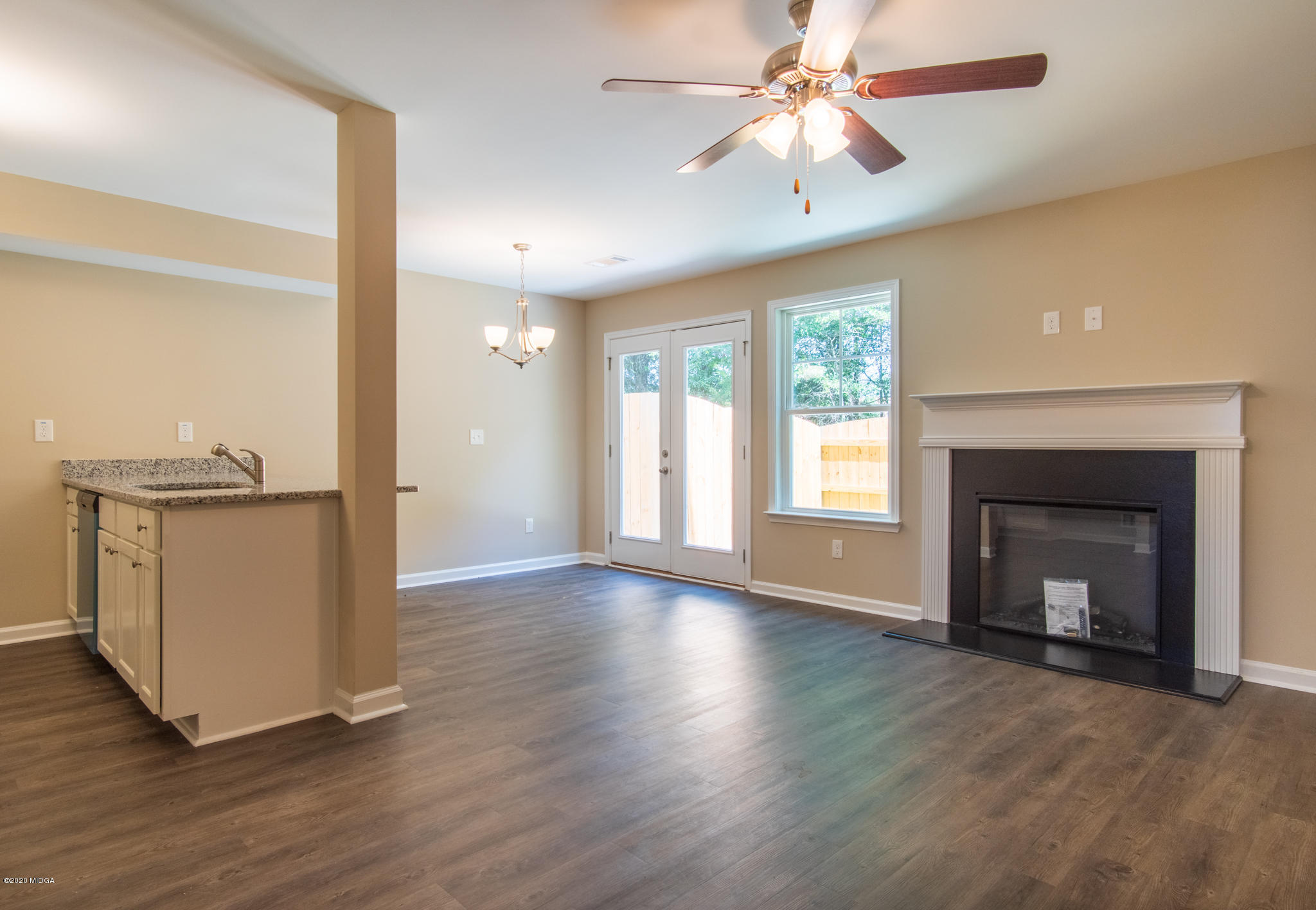 301 Pond View Road Macon, GA 31206 - Photo 2 of 20 wooden floor fireplace and windows in an empty room