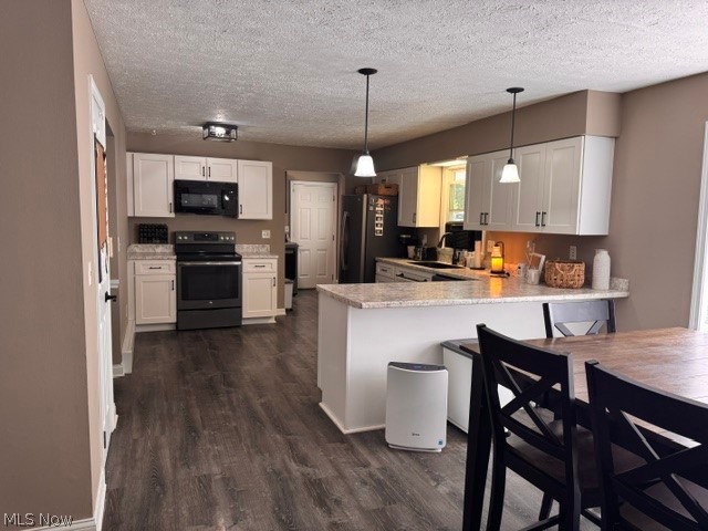 2760 Haines Road Madison, OH 44057 - Photo 18 of 33 Open-concept kitchen featuring white cabinetry, wood-finish flooring, and light-toned countertops