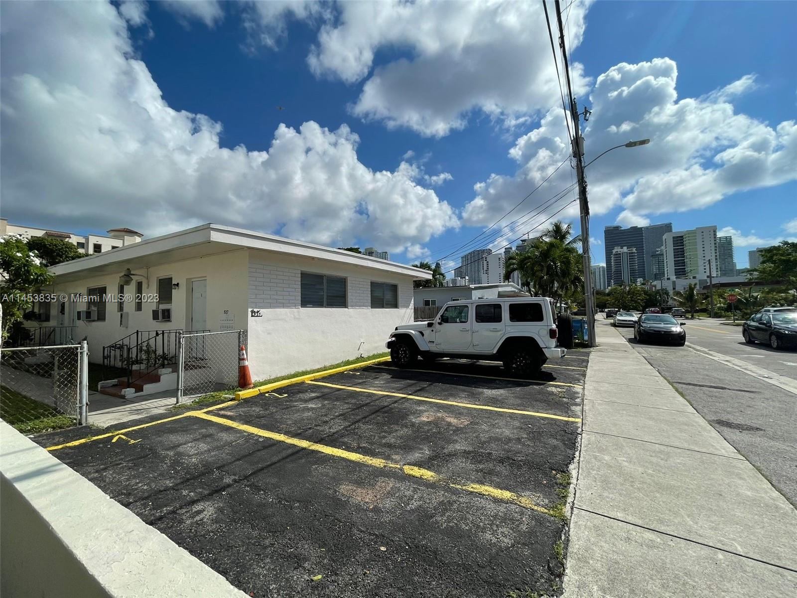 a view of a car park in front of house