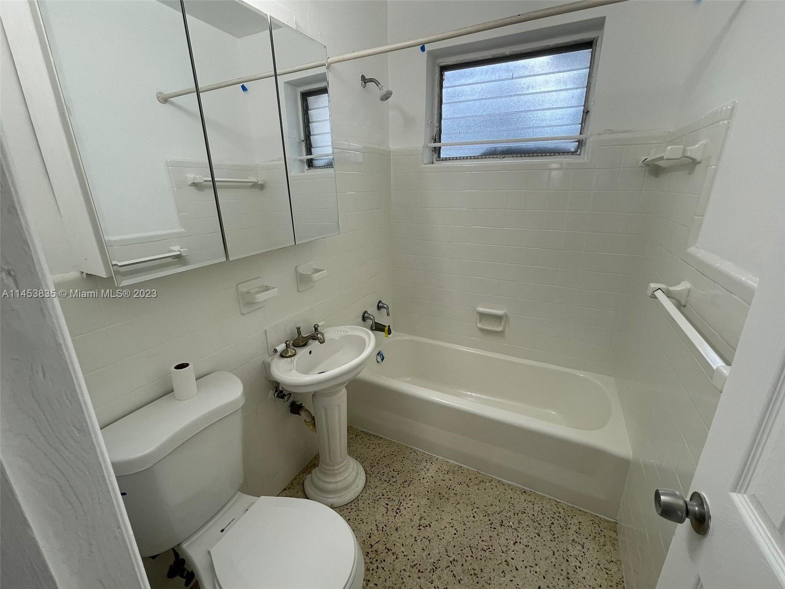 The Roads Miami, FL 33130 - Photo 2 of 3 a white toilet sitting next to a bath tub shower