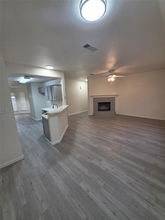 1750 Oneal Street Lancaster, TX 75134 - Photo 2 of 14 a view of a big room with wooden floor fireplace and windows