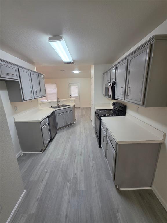 1750 Oneal Street Lancaster, TX 75134 - Photo 3 of 14 a kitchen with a sink a counter top space stainless steel appliances and cabinets